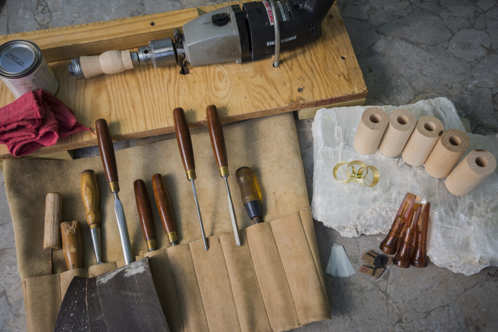 The different pieces needed to make a duck call on a workshop table