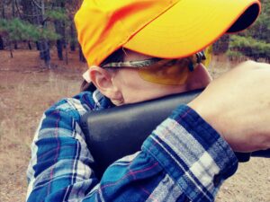 the author demonstrating the correct way to shoulder a shotgun