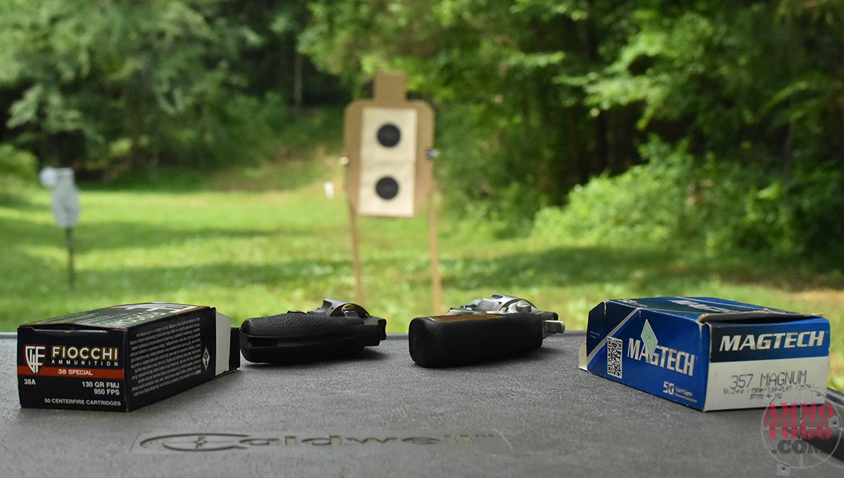 boxes of 38 special and 357 mag ammo with revolvers at a shooting range