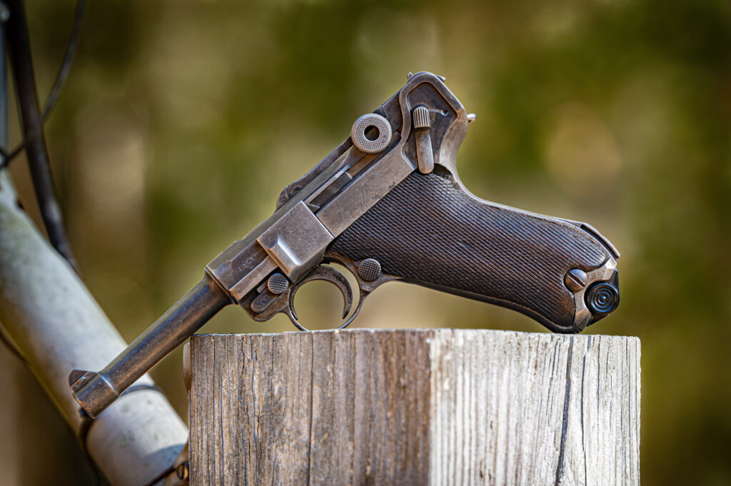 9mm Parabellum 08 pistol - The Luger displayed on a wooden fence post