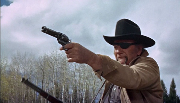 John Wayne Played Rooster Cogburn and fired several guns in the movie True Grit