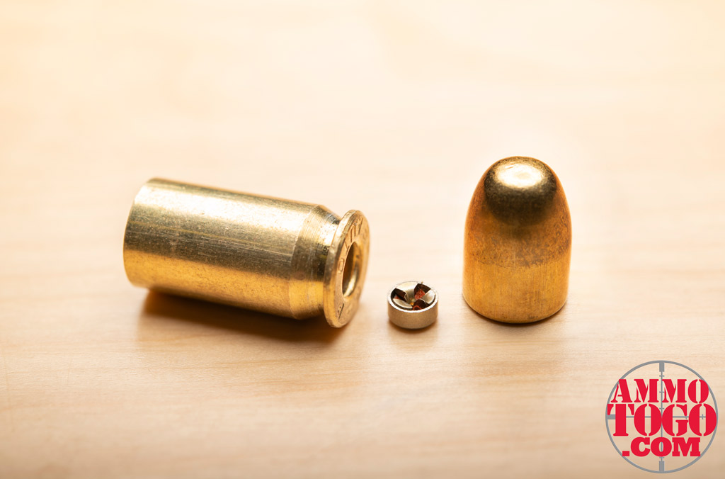 A photo of a dissembled FMJ 9mm bullet showing the basic parts of ammunition