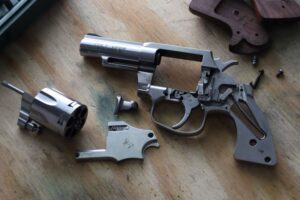 A field stripped Colt Viper revolver on a table