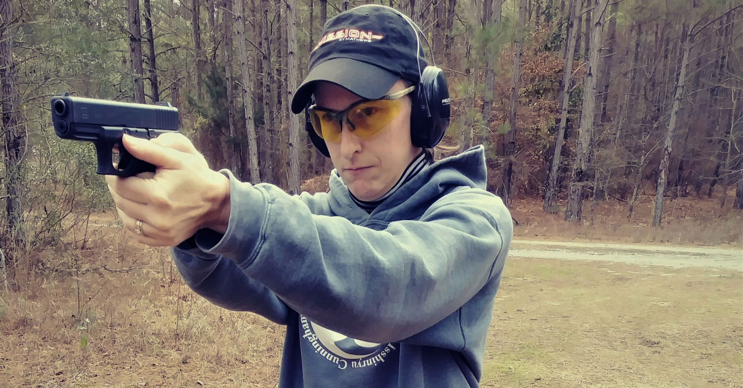 The author demonstrating proper pistol shooting stance at the shooting range