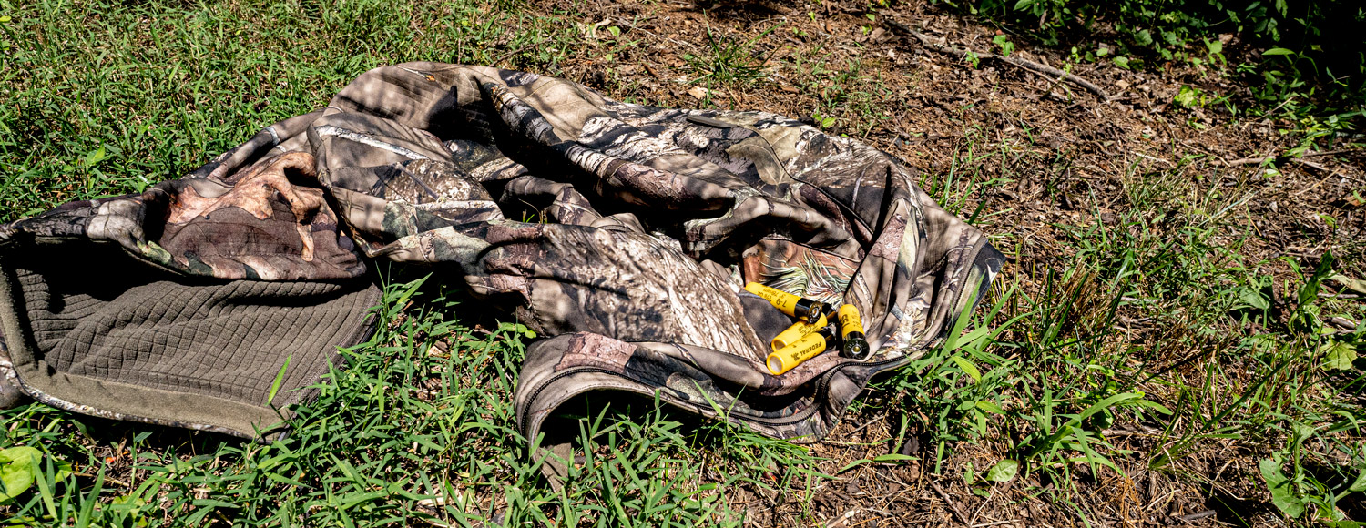 Rabbit hunting ammo and gear laying in a field