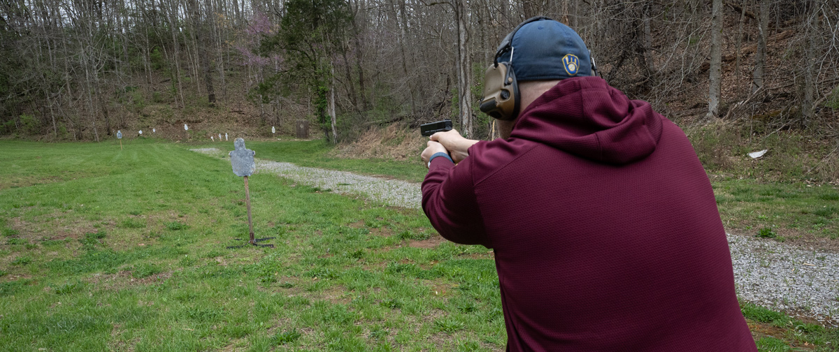 The author firing 9mm rounds at the shooting range
