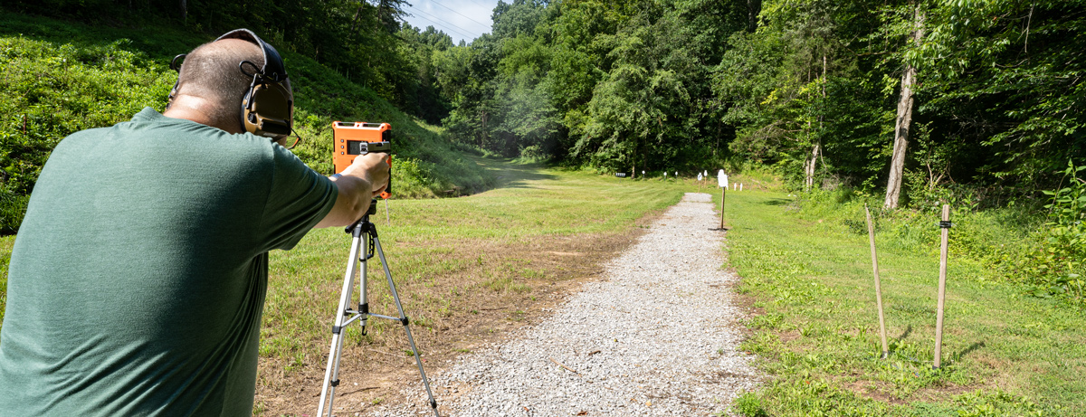 Shooting 9mm pistol with a chronograph at the range